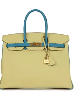 Hermès Special Order (HSS) Birkin 35 Jaune and Bleu Paradise The interior is lined with Bleu Paradise chevre and has one zip pocket with an Hermes engraved zipper pull and two open pockets on the opposite side. Collection: T Origin: France Condition: Pre-owned; Mint - the bag retains its structure. There is no wear to the exterior leather. The hardware shows light scratching. The interior is clean. Accompanied by: Hermes box, Hermes dustbag, clochette, lock, two keys, clochette dustbag, rainhat and carebook Measurements: 13.75" width x 11" height x 7" depth; 4.25" handle drop