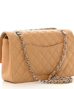 Madison Avenue Couture offers a brand-new, unworn Chanel Medium Double Flap Bag in Beige Caviar Leather with Silver Hardware.