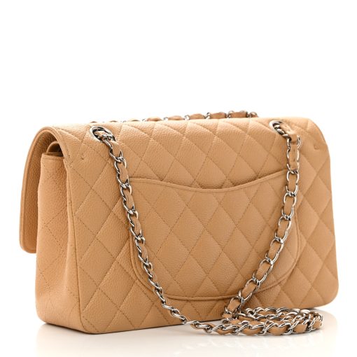 Madison Avenue Couture offers a brand-new, unworn Chanel Medium Double Flap Bag in Beige Caviar Leather with Silver Hardware.