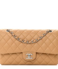 Madison Avenue Couture offers a brand-new, unworn Chanel Medium Double Flap Bag in Beige Caviar Leather with Silver Hardware.